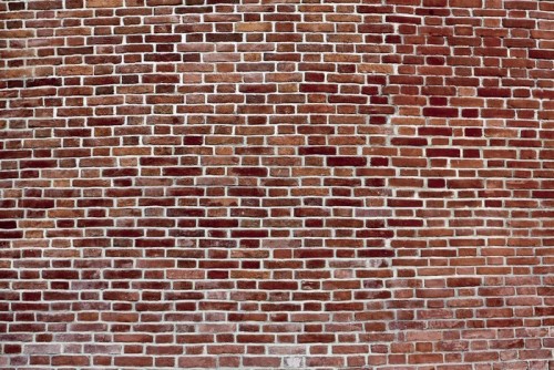 Fototapeta Wypukły ciemnym tle czerwony mur z cegły
